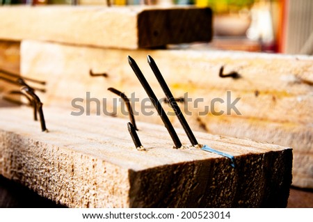 Old Rust Sharp Steel Nail in Carpentry Wood Plank in Carpentry Business and Carpenter Wood Work.