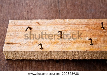 Old Rust Sharp Steel Nail in Carpentry Wood Plank in Carpentry Business and Carpenter Wood Work.