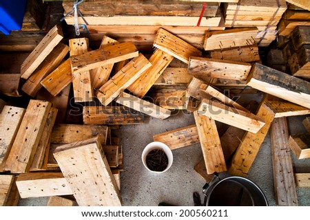 Heap of Old Wood Plank with Box Cup of Rust Nail in Carpentry Business and Carpenter Wood Work for Background and Texture.
