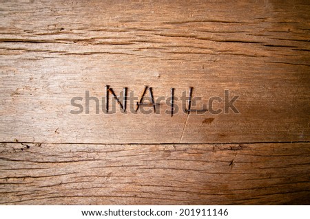 Old Vintage Rust Nails Arranged in Word Text Represent NAIL on Wood Table Background, Rustic Style.