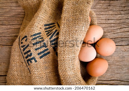 Fresh Egg With Burlap Sack Harvest on Wooden Table Background, Food Rustic Still Life Style. Concept and Idea for Homemade Food Art Decoration.