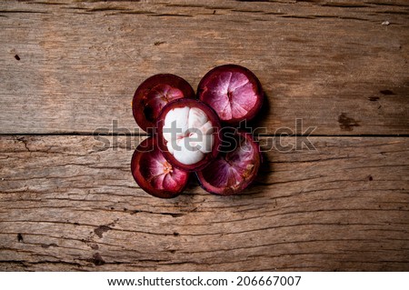 Half Cut Sliced Mangosteen with Shell Harvest on Wood Table Background, Concept and Idea of Food and Fruit, Rustic Still Life Style