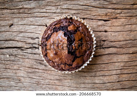 Chocolate muffins with crispy top on Wood Table Background, Rustic Still Life Style / Concept and Idea of Sweet Food Bakery Dessert Time, To Eat with Coffee or Hot Drink in the Morning or Tea Time.
