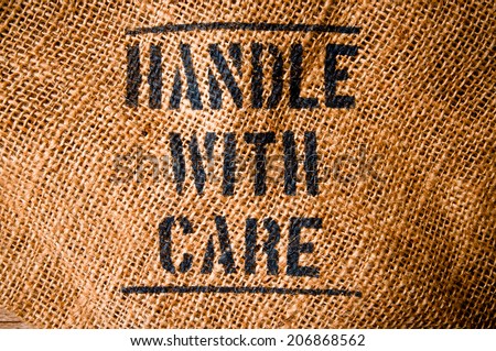 Vintage Burlap Bag with Handle with Care word text screen for Concept and Idea of Food, Art, Object, Kitchen Background and Textured, Country Rustic Still Life Style.