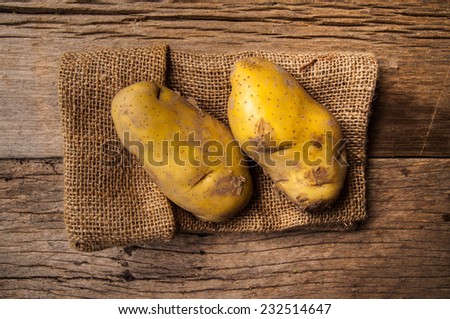 Fresh Potato with Vintage Burlap Bag on Wood Table Background, Concept and Idea of Food Cook Rustic Still life Style.