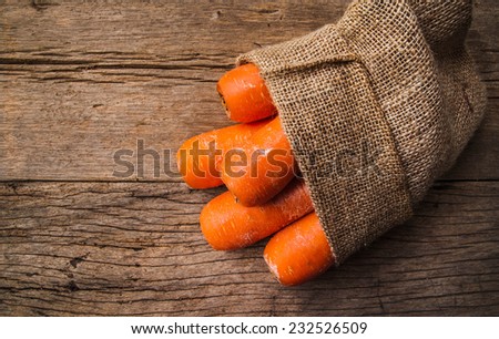 Fresh Harvest Carrot with Vintage Burlap Bag on Wood Table Background, Concept and Idea of Food Cook Rustic Still life Style.