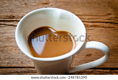 Valentine Day Concept and Idea. Coffee Mug in Design of Heart Shape, Love and romantic idea on Wood Table Background, Food Rustic Still Life Style.