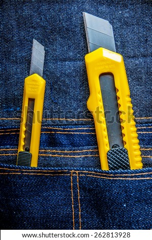 Two Stationery Knife Paper Cutter Small and Big, Opened, Sharp in Denim Tool Bag. / Concept and Idea of Industrial, Handmade, Home Improvement, Worker, Business or Art Crafts.