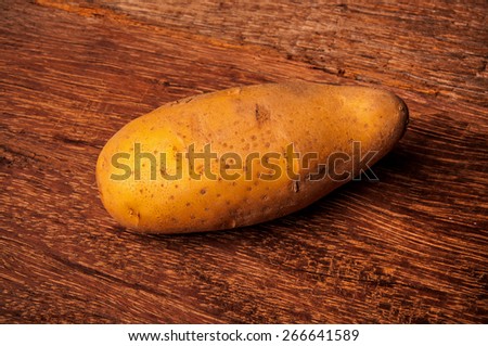 Fresh Potato on Wood Table Background, Concept and Idea of Food, Cook, Harvest, Organic Farm Life, Rustic Still life Style. Close up.