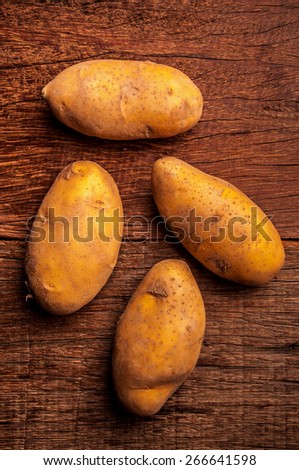 Fresh Potato on Wood Table Background, Concept and Idea of Food, Cook, Harvest, Organic Farm Life, Rustic Still life Style. Vertical.