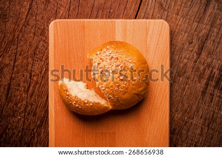 Homemade Fresh Baked Sweet Round Bread in Piece Served on Wood Cutting Board, Table Background, Vintage Rustic Still Life Style / Concept and Idea of Breakfast, Food, Bakery, Dessert Pastry.