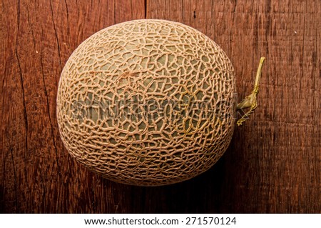 Cantaloupe Melon or Honeydew Melon, Green, Full on Wood Table Background.