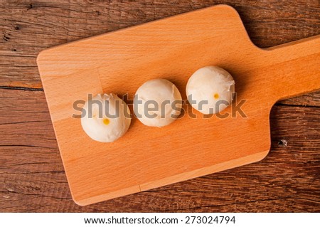 Asian Traditional Dessert, Chinese Cake, Moon Cake, Thai Cake or Chinese Pastry. Filled with Bean Paste and Egg Yolk. Delicious Dessert. / Top View On Wood Background.