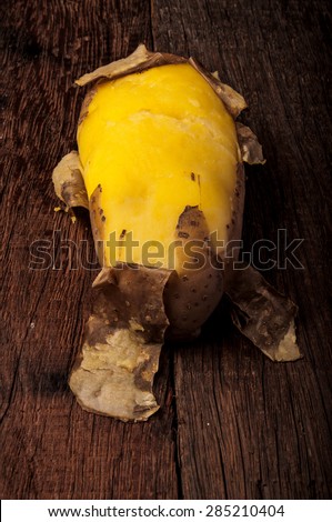 Fresh Hot Boiled Potato with Peeled Skins on Wood Table Background, Concept and Idea of Food Cook Rustic Still life Style. Vertical.