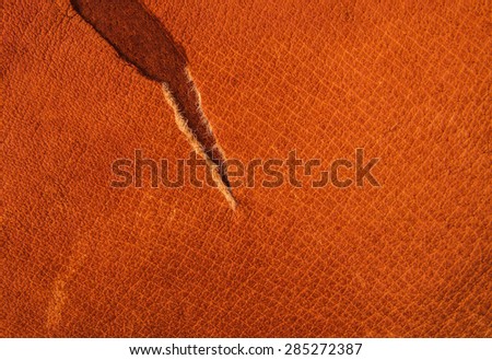 Torn Brown, Orange Leather for Concept and Idea Style of Fine Leather Crafting, Handcrafts, Handmade, handcrafted, leather worker. Background Textured and Wallpaper. Rustic Style.