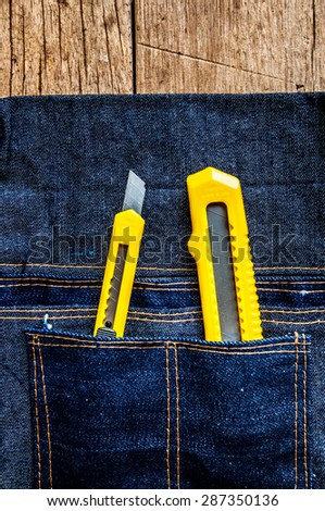Two Stationery Knife Paper Cutter Small and Big in Denim Tool Bag. / Concept and Idea of Industrial, Handmade, Home Improvement, Worker, Business or Art Crafts.
