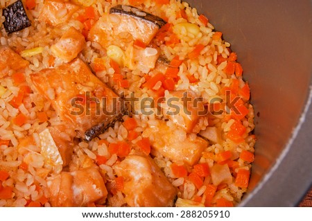 Salmon Garlic Rice, Fried and Steamed with Carrot and Teriyaki Sauce in Slow Rice Cooker, Japanese Healthy Style, (similar to Pilaf), Homemade Cooking Idea, Delicious, Rustic Still Life.