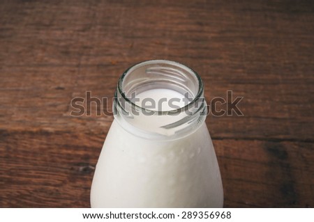 Fresh Milk Glasses Bottle Opened, Organic Dairy Produce, Concept and Idea of Breakfast on Wood Table Background, Country Rustic Still Life Style.