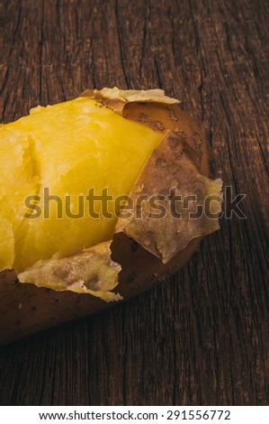 Fresh Hot Boiled Potato with Peeled Skins on Wood Table Background, Concept and Idea of Food Cook Rustic Still life Style. Close up Vertical.