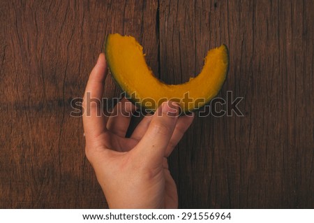 Fresh Hot Steamed Boiled Pumpkin, Hand Holding on Wood Table Background, Concept and Idea of Food Cook Rustic Still life Style.