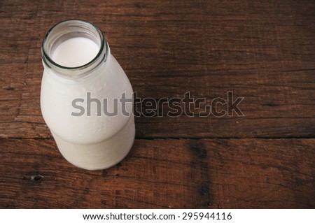 Fresh Milk Glasses Bottle Opened, Ready to Drink, Organic Dairy Produce, Concept and Idea of Breakfast on Wood Table Background, Country Rustic Still Life Style.