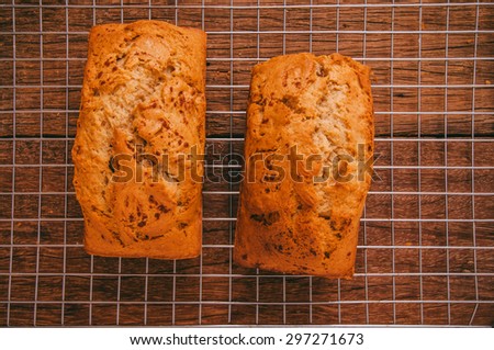 Banana Bread Loaf, Homemade Fresh Baked from Oven on Cooking Rack and Wood Table Background, Vintage Country Rustic Still Life Style. Concept and Idea of Breakfast, Bakery. Top View.
