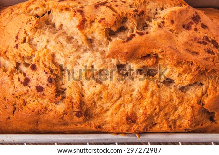 Banana Bread Loaf, Homemade Fresh Baked from Oven in Square Tin Pan and Cooking Rack, Isolated on White Background. Concept and Idea of Breakfast, Bakery. Close up.