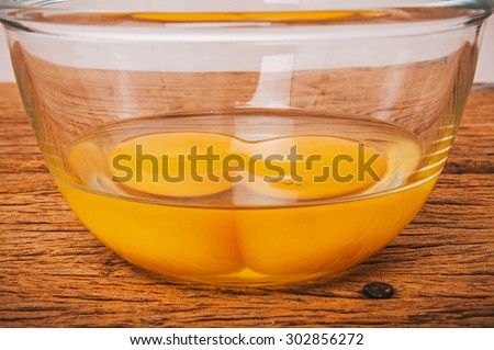 Fresh Eggs, Twin Egg Yolk in Glasses Bowl on Wooden Table Background, Country Rustic Style. Concept Idea of Cooking and Baking. Selective Focus.