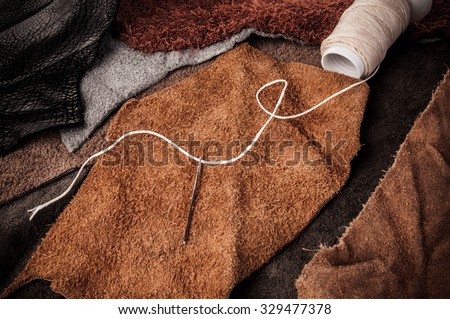 Leather Crafting Workspace with Wax Cord and Leather Thread Reel. Artisan Crafts, Leather, Fashion or Furniture Industry with Leather Pieces Workspace, Background Wallpaper and Textured. Rustic Style.