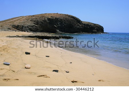 Sand beach and footsteps. Playa de Puerto Muelas, Lanzarote.