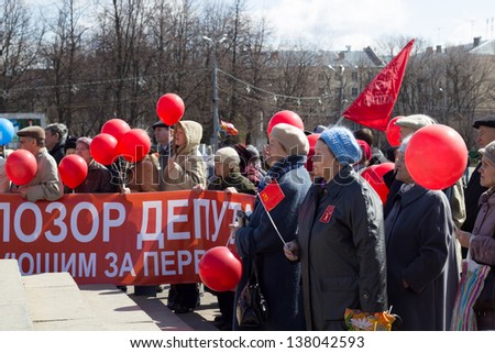 KIROV, RUSSIA - MAY 1: Citizens participate in the rally of International Workers\' Day event on May 1, 2013 in Kirov, Russia. People listen to the orator. Banner: \