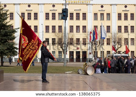 KIROV, RUSSIA - MAY 1: Rally of International Workers' Day event on May 1, 2013 in Kirov, Russia. Flag bearer of the Kirov Regional Organization of the Communist Party (CPRF).