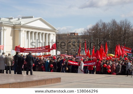 KIROV, RUSSIA - MAY 1: Citizens participate in the rally of International Workers\' Day event on May 1, 2013 in Kirov, Russia. Orator on stage. Banners: \
