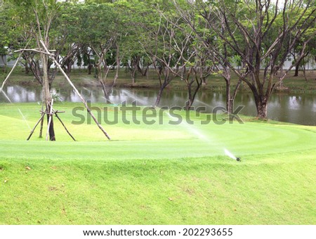 Sprinkler watering lawns, parks, golf courses, nature reasserted.