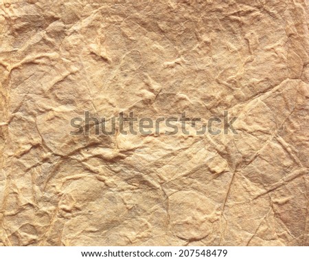 Creases subjected dan brown paper texture pattern abstract background.