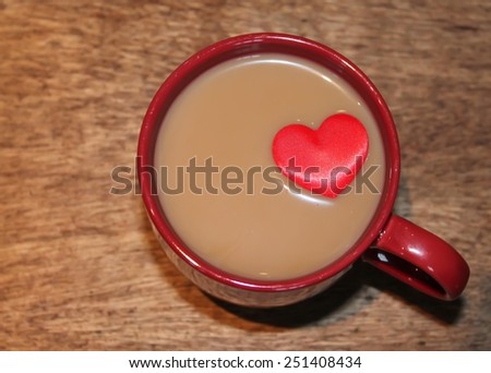 Milky Coffee in a red mug with a red love heart floating on top