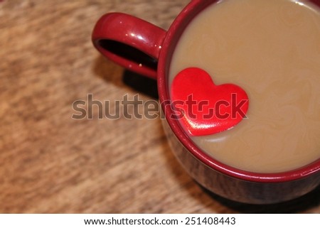 Milky Coffee in a red mug with a red love heart floating on top