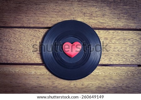 Music Lover - Vinyl with red love heart on a wooden surface