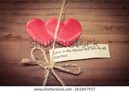 Two hearts tied together with the quote - Love is the thread that ties us all together