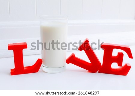 Live Love Milk - A glass of fresh milk within red letters spelling 'live' or 'love'