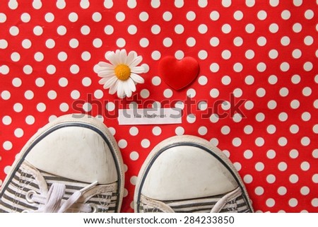 Live in the Present - Message next to a love heart, a daisy and striped pumps on red polka dots