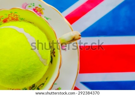 British Tennis - A cup and saucer  on a Union Jack flag with a tennis ball inside