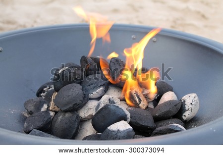 Outdoor portable fire pit with burning coal