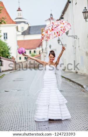 Young bride on her wedding day in the rain
