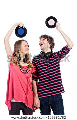 Happy young couple playing around with vinyl records isolated on a white background