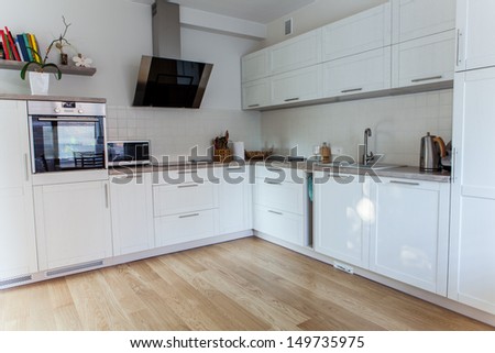 Inside of a modern kitchen with minimal furniture