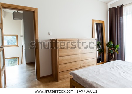 Inside of a modern bedroom with minimal furniture