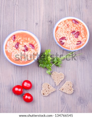 Soup with rice and beans on  wooden background