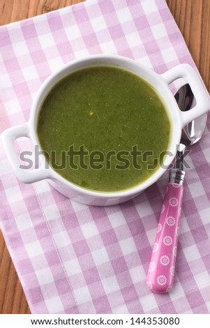 Spinach soup on a wooden background