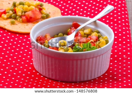 Salad with corn, tomatoes, paprika and pea. Wrap with salad